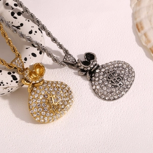 Detailed view of gold and silver money bag pendants with pavé crystals on rope chains