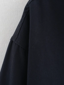Macro shot of navy blue woven fabric detail with precision stitching and fine texture