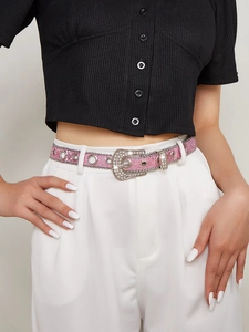 Pink glitter belt with rhinestone buckle and metal chain trim detail on white pants
