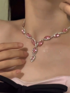 Close-up of elegant pink marquise crystal necklace in Y-shape on a female model
