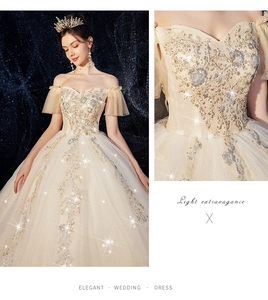 Close-up of champagne off-shoulder wedding dress with sequined floral embroidery