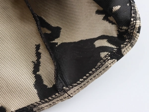 Detail of elegant beige and black jacquard fabric with mesh lining and refined stitching