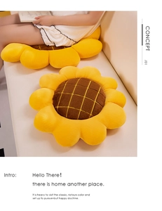 Detailed view of plush sunflower floor cushion featuring yellow petals and grid texture