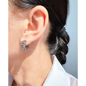Minimalist silver ribbon-style stacked hoop earrings with textured metal finish