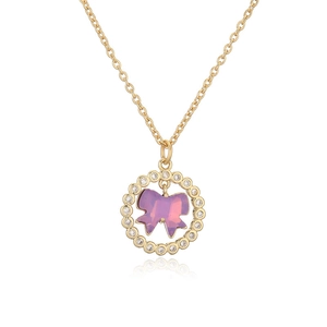 Golden necklace with a crystal-encrusted oval pendant and a pink purple glass bow charm