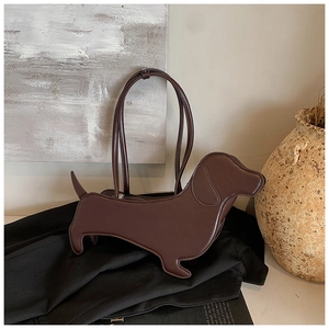 Detail of dachshund-shaped dark brown shoulder bag in glossy leather finish