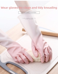 Close-up of pink gradient waterproof latex gloves with non-slip texture on wooden surface