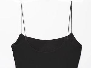 Close-up of neckline and thin spaghetti straps on a sexy black slim fit top