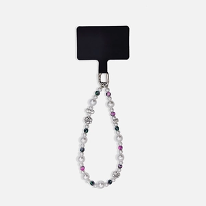 Detail of beaded phone strap with pearls, purple accents, and silver flower ornaments