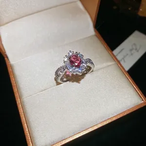 Elegant silver open ring with oval pink zircon centerpiece and flower halo detail