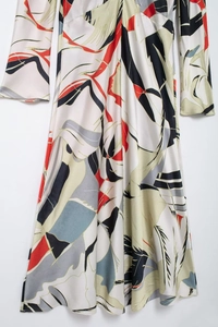Macro detail of elegant satin shirt dress featuring colorful geometric abstract patterns