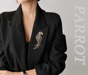 Detail of colorful crystal parrot brooch on a black suit jacket lapel with shimmering effect