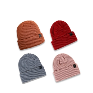 Minimalist ribbed knit beanies in four colors with stylish black leather label patches