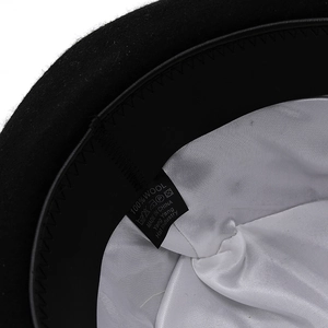 Detail of 100% wool dome hat interior with white silk lining and premium washing label
