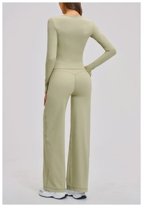 Detail view of the back V-shaped stitching on high-waisted green yoga wide-leg pants
