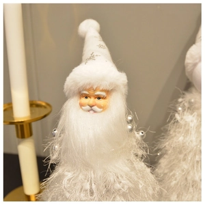 Detail of plush Santa Claus figure with soft white knit textures and festive gold accents