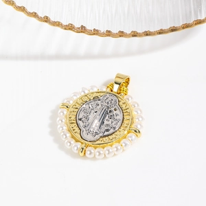 Macro view of two-tone religious Virgin Mary pendant with woven edge and pearls