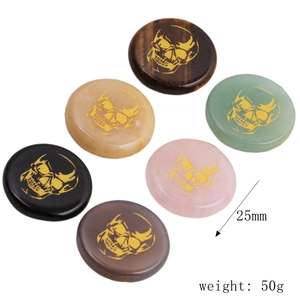 Set of six 25mm natural crystal stones with gold skull patterns and 50g total weight