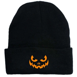 Detail of black knit beanie featuring an orange Halloween pumpkin face embroidery