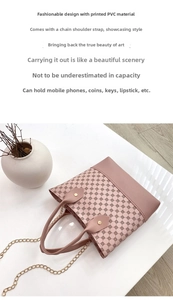 Top view of pink geometric floral printed handbag with metal chain strap on marble