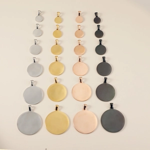 Polished round stainless steel pendants in four finishes and multiple sizes on grid