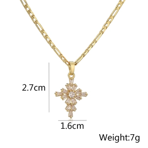 Detailed size view of a gold cross pendant necklace with zircon stones on Figaro chain