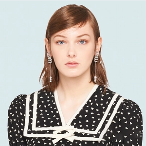 Silver drop earrings featuring crystal MIU letters with dangling chain and gemstone