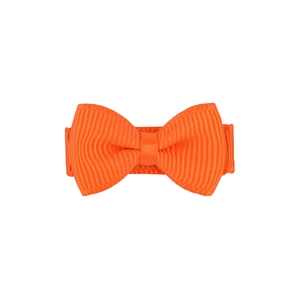 Close-up of orange fabric bow clip showing detailed ribbed texture and soft material