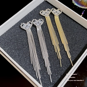 Elegant gold and silver heart tassel earrings with sparkling rhinestones in a gift box