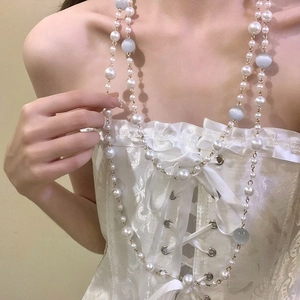 Baroque retro pearl and cat eye stone layered necklace worn on a white lace top