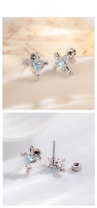 Detail of silver cross stud earring with blue heart gem and screw back flat closure