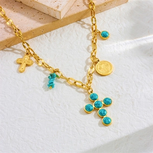 Gold stainless steel cross necklace with turquoise beads and coin pendant on stone base