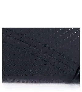 Close-up of laser-cut perforated fabric and reinforced stitching on a black baseball cap