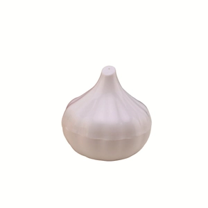 Macro detail of a white garlic-shaped plastic seasoning container with top holes
