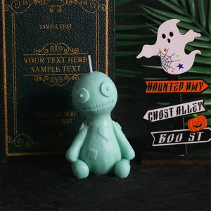 Mint green Voodoo Doll candle mold with heart patch detail on spooky background