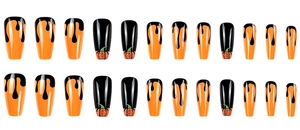 Detail of black and orange drip halloween false nails with glittery pumpkin design