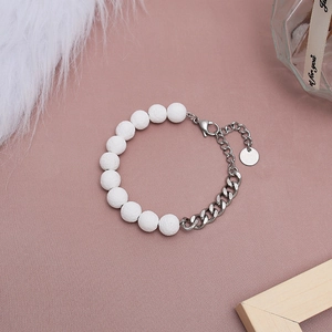 Detail view of white lava beads and silver stainless steel link chain bracelet for unisex