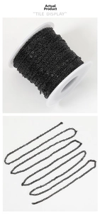 Macro detail of black stainless steel O-link chain for DIY jewelry making on white spool