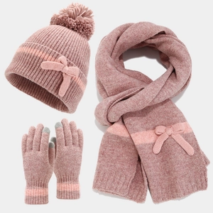 Detail of pink knitted winter set featuring ribbon bow decor and touch-screen fingertips