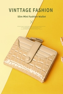 Detail of light beige crocodile pattern leather wallet with premium metal zipper