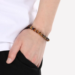 Detailed close-up of tiger eye stone bead bracelet with silver spacers on wrist