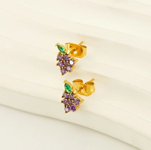 Detail of grape shape stud earrings with purple zircons and green leaf on gold base