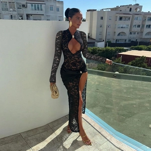 Detailed view of intricate black lace texture and daring cutout design on a maxi dress