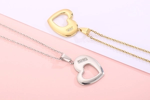 Detail showing heart hollow pendants in gold and silver finish with small zircons