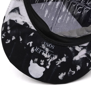 Detail of flat brim baseball cap featuring monochrome portrait print and Cayler Sons logo