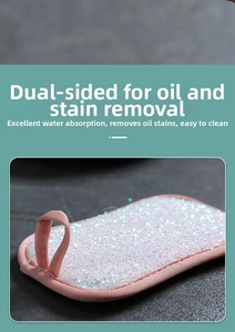 Detail of double-sided dishwashing sponge with pink fabric edging and hanging loop