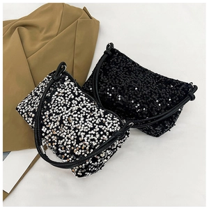 Close-up of black and silver sequined baguette bags with glossy round texture