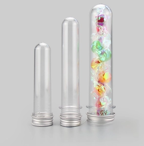 Detailed view of clear PET test tubes with silver screw caps in three sizes with candy