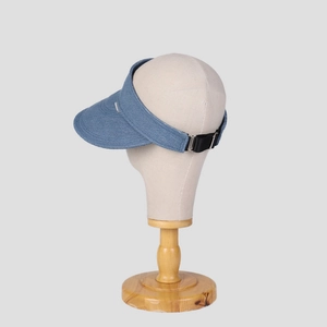 Detailed side-back view of blue denim sun visor with adjustable strap on mannequin