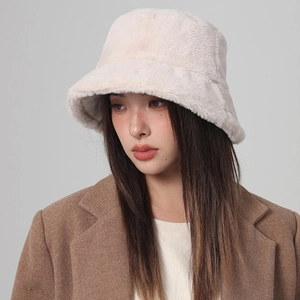 Detail shot of the thick faux fur texture on a warm beige winter bucket hat